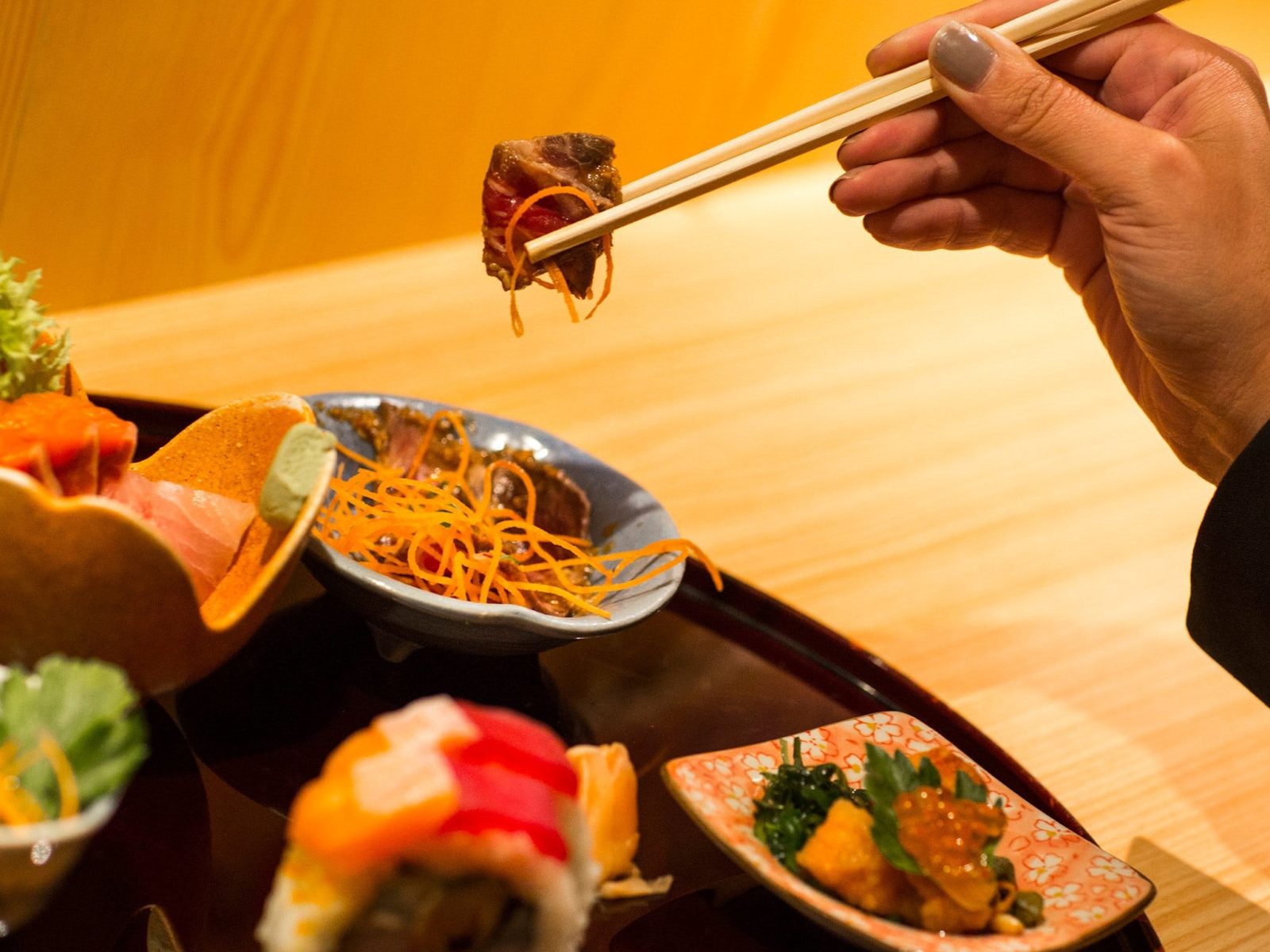 Hand holding japanese food in chopsticks