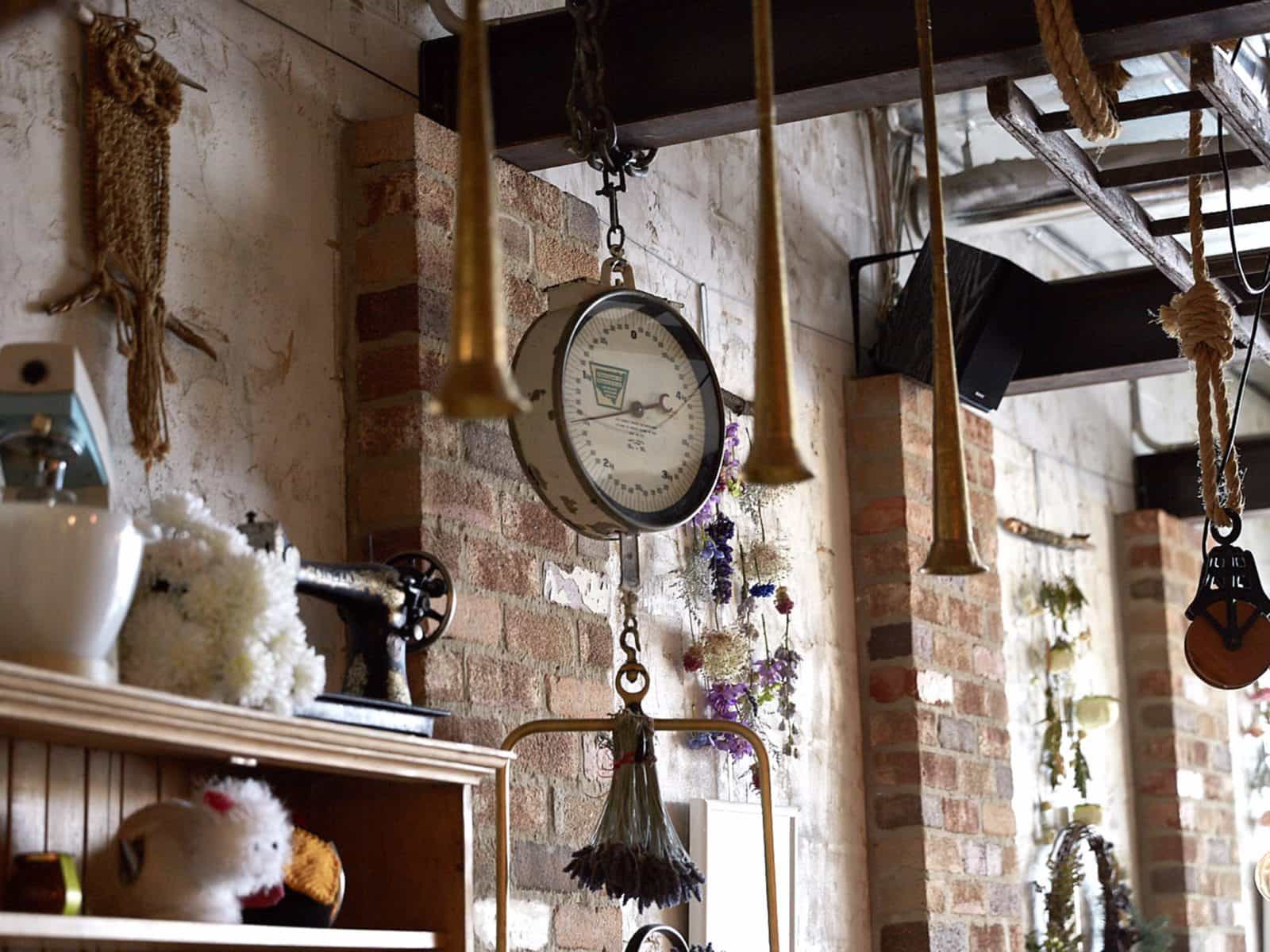 Quirky hanging objects from wooden beams and exposed brick walls