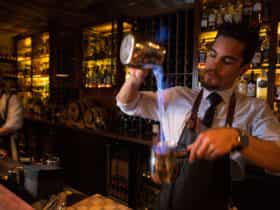 Bartender making flaming cocktails