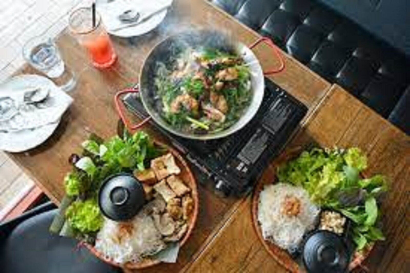 Asian dishes steaming laid out on a table