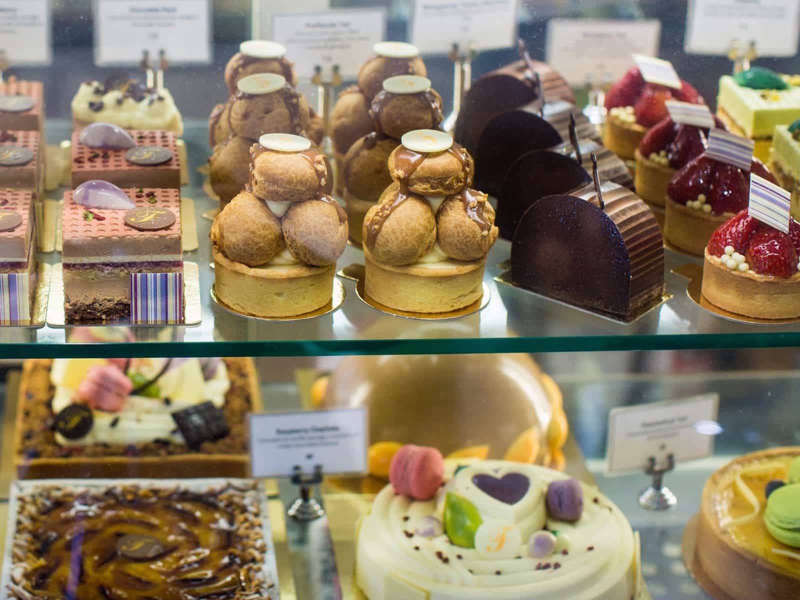 Display case of large and small cakes
