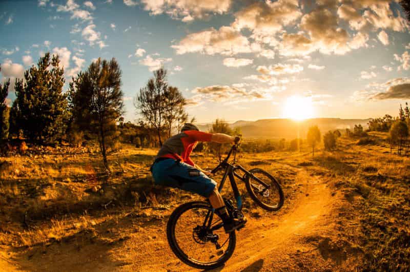 Mountain biker on a trail as the sun comes up