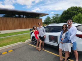 two couples posing next to tour car at Shaw Wines