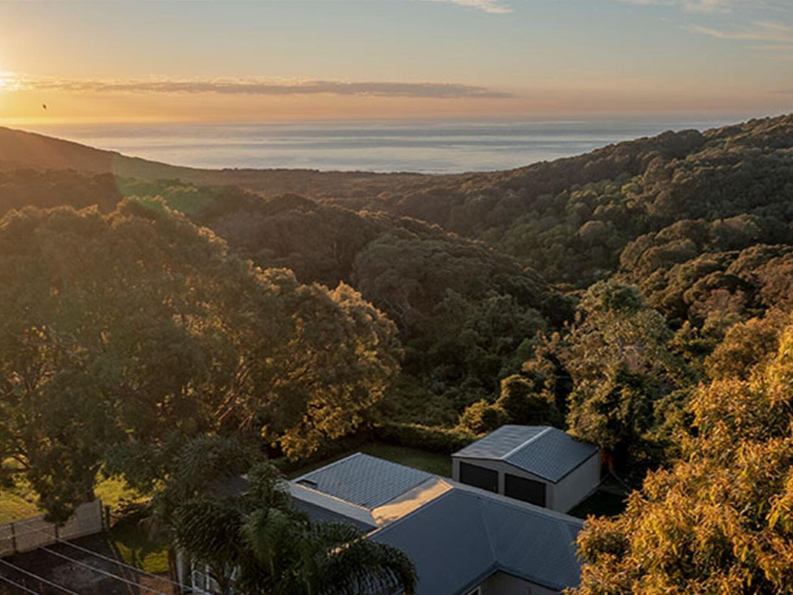 An aerial view of the ocean and Baileys Cottage in Glenrock State Conservation Area. Photo: John