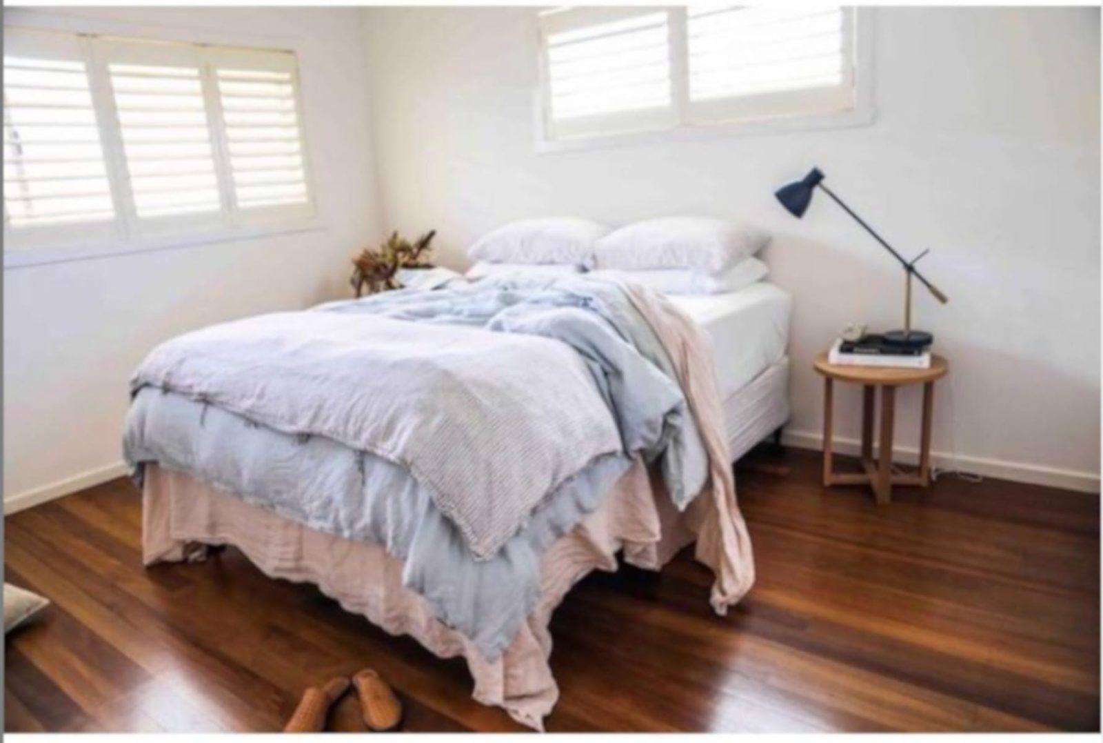 bedroom photo a beautiful comfy bed in a light filled room with timber floors
