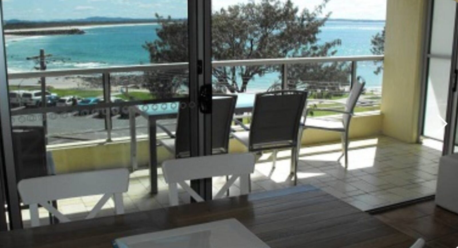 Dining area, looking out to balcony, outdoor setting and ocean views