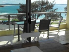 Dining area, looking out to balcony, outdoor setting and ocean views