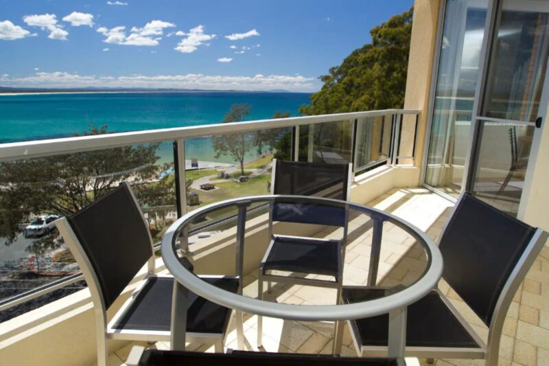 Balcony with ocean views and 4 seater dining setting
