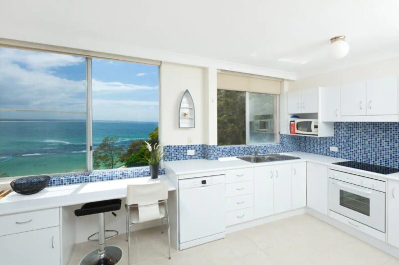 Kitchen with breakfast bar, dishwasher, oven, microwave, ocean views