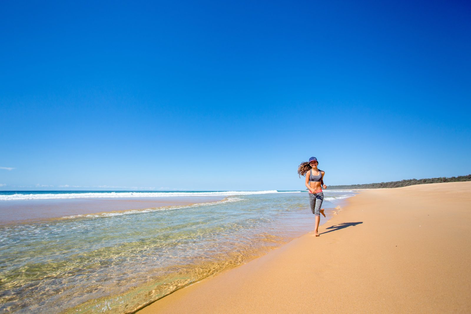 Girl running along the pristine Dolphin Beach