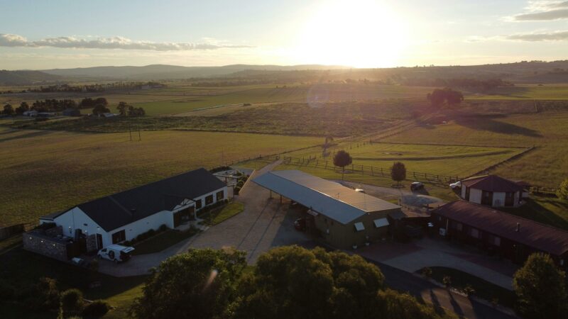 Sunset at our farm; in view is the function centre, bunkhouse, train and yurt accommodation options.