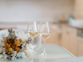 Two glasses of white wine with a bunch of flowers. Enjoy time with friends.