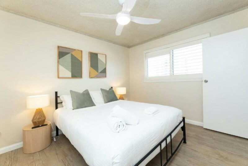 Master bedroom with ceiling fan and Queen bed adorned with hotel grade linen
