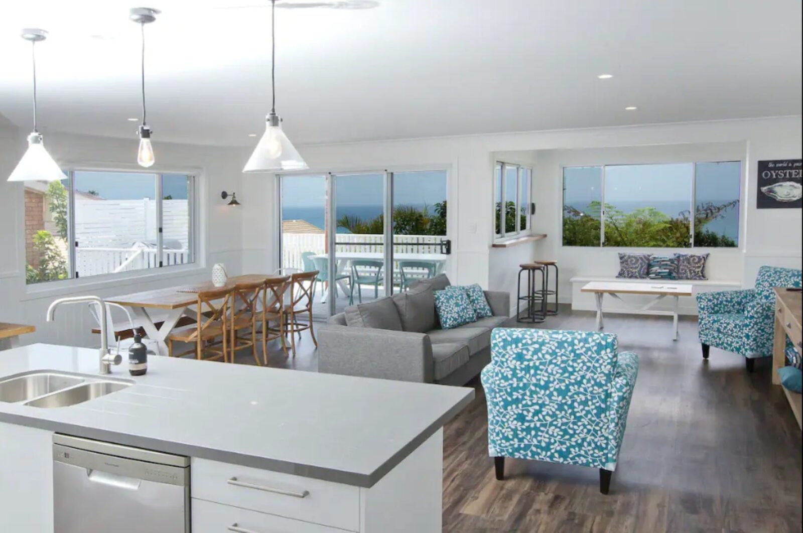 Modern, coastal styled living and dining areas leading on to balcony