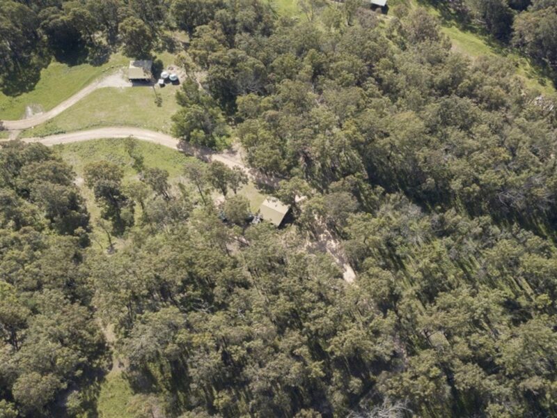 Aerial shot of Galong cabins surrounded by remote wilderness in the Southern Blue Mountains area of