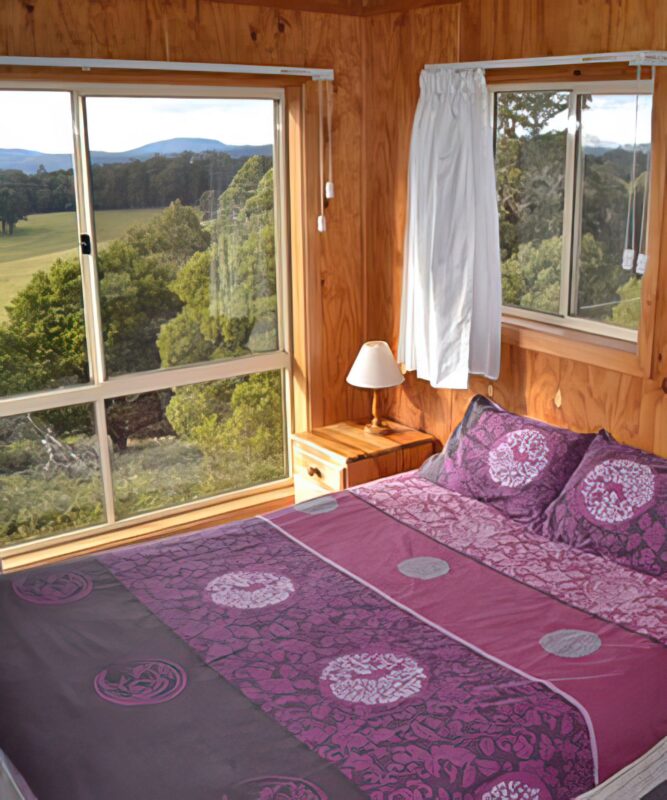 Purple bed, window in background, jenolan cabins