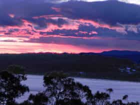 View of setting sun over Batemans Bay from the Apartments' upper deck at Longbeach Clifftop Retreat