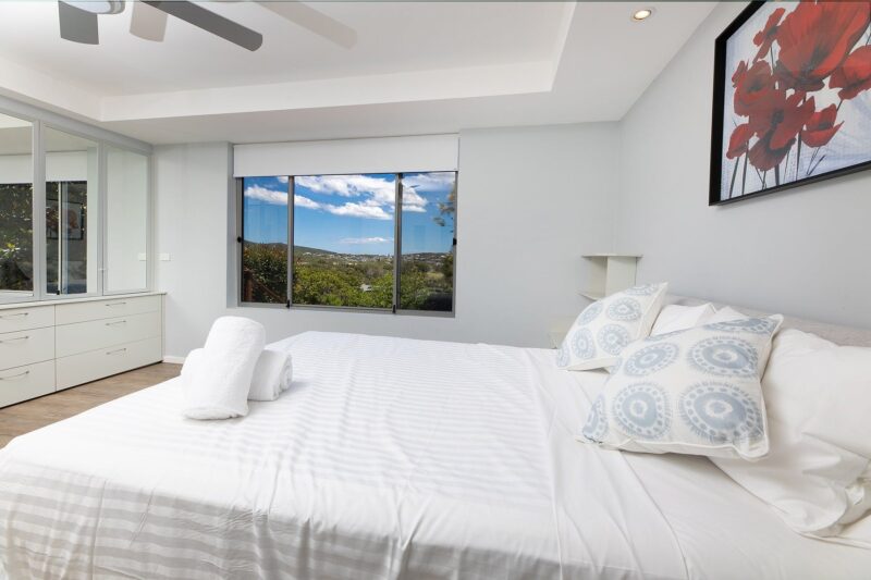 Bedroom with Queen bed, ceiling fan and mountain views