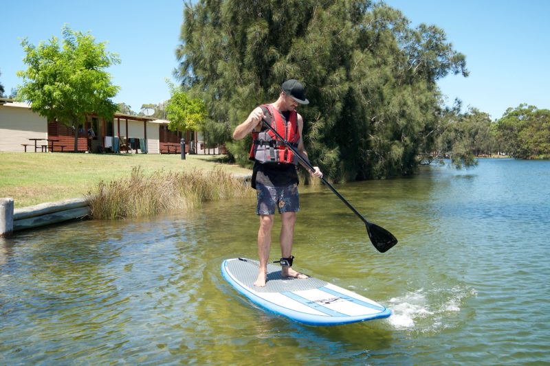 Guest on stand up paddle board