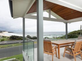 Balcony with outdoor dining setting and beach views