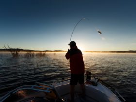 Fishing from a boat on Copeton Dam at Reflections Holiday Parks.