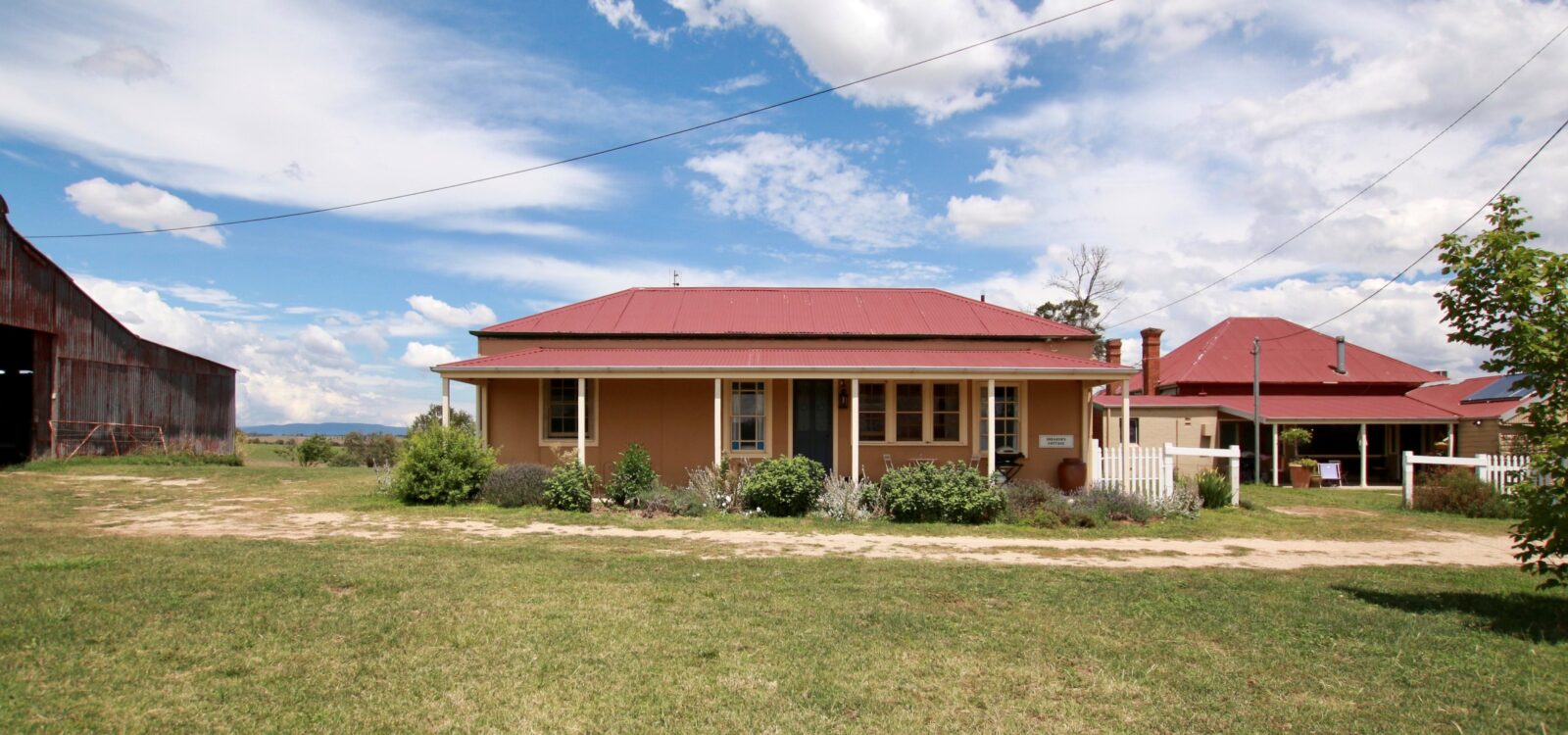 Red brick home, paddock, red tin roof