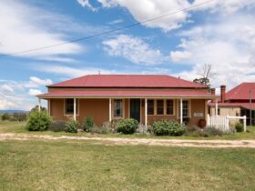 Red brick home, paddock, red tin roof