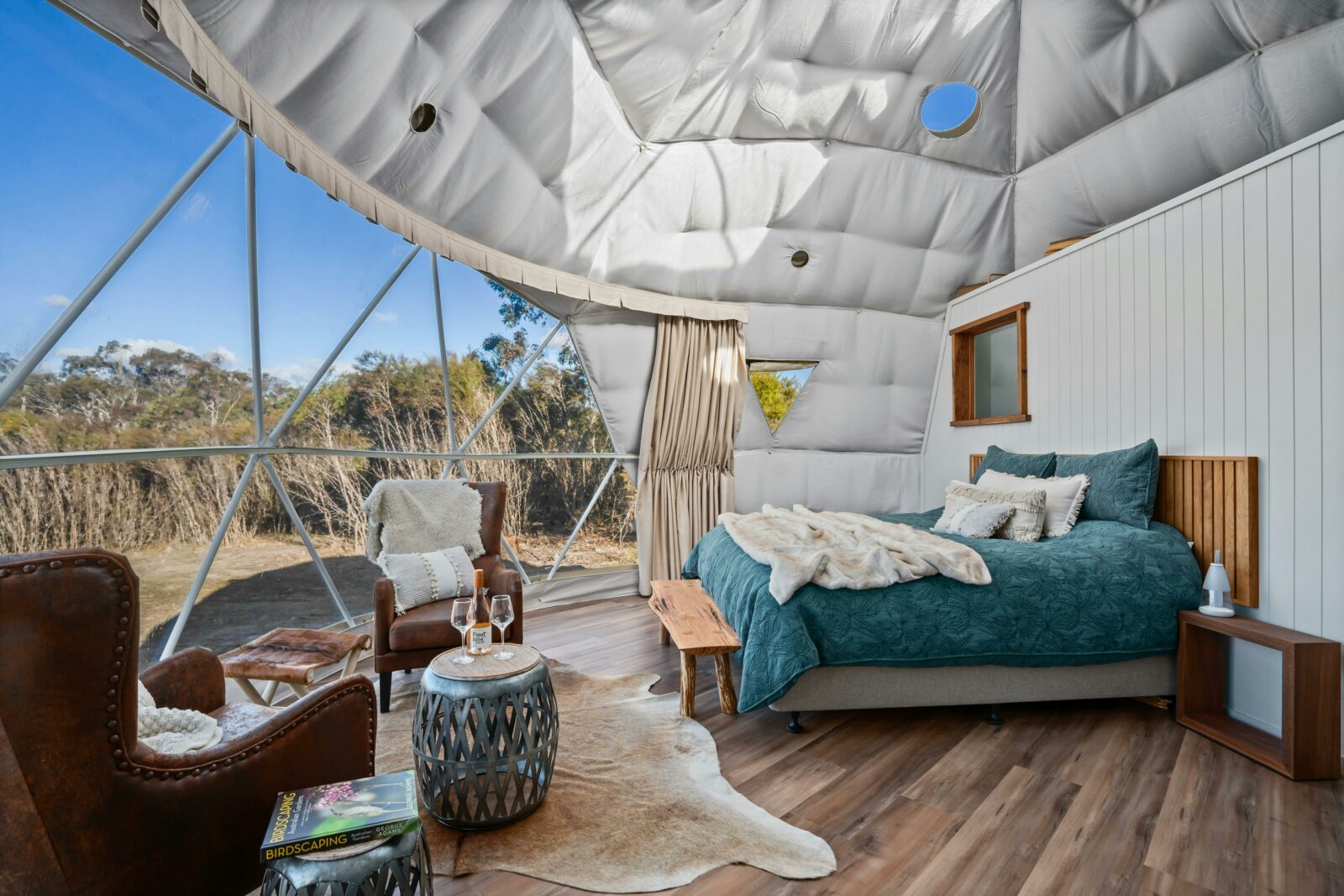 Banjos Camp dome interior showcasing king-size bed and view