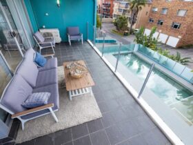 Balcony with casual lounge setting, overlooking pool