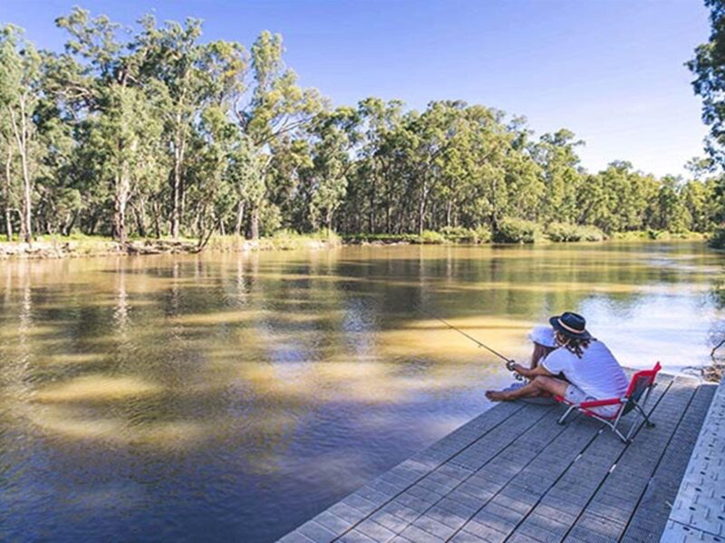 Father and daughter fishing from a deck, Swifts Creek campground, Murray River National Park. Photo: