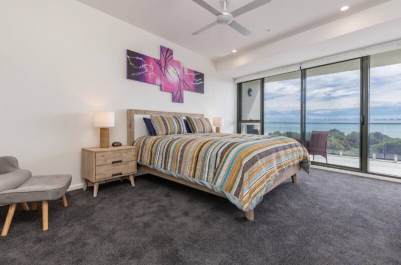 Master bedroom with ceiling fan, ocean views, King bed