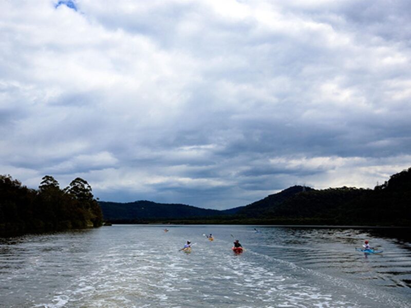 A group of kayakers on the Hawkesbury River on a cloudy day. Photo: Rosie Nicolai/DPIE.