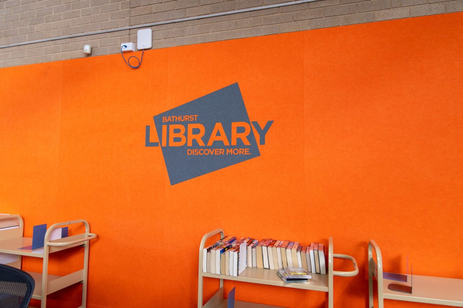 Bathurst city library logo on a wall.