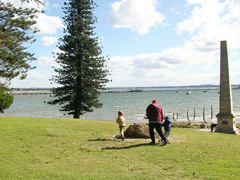 Family walking on the hill above the Captain Cook Monument. Photo credit: Natasha Webb © DPIE