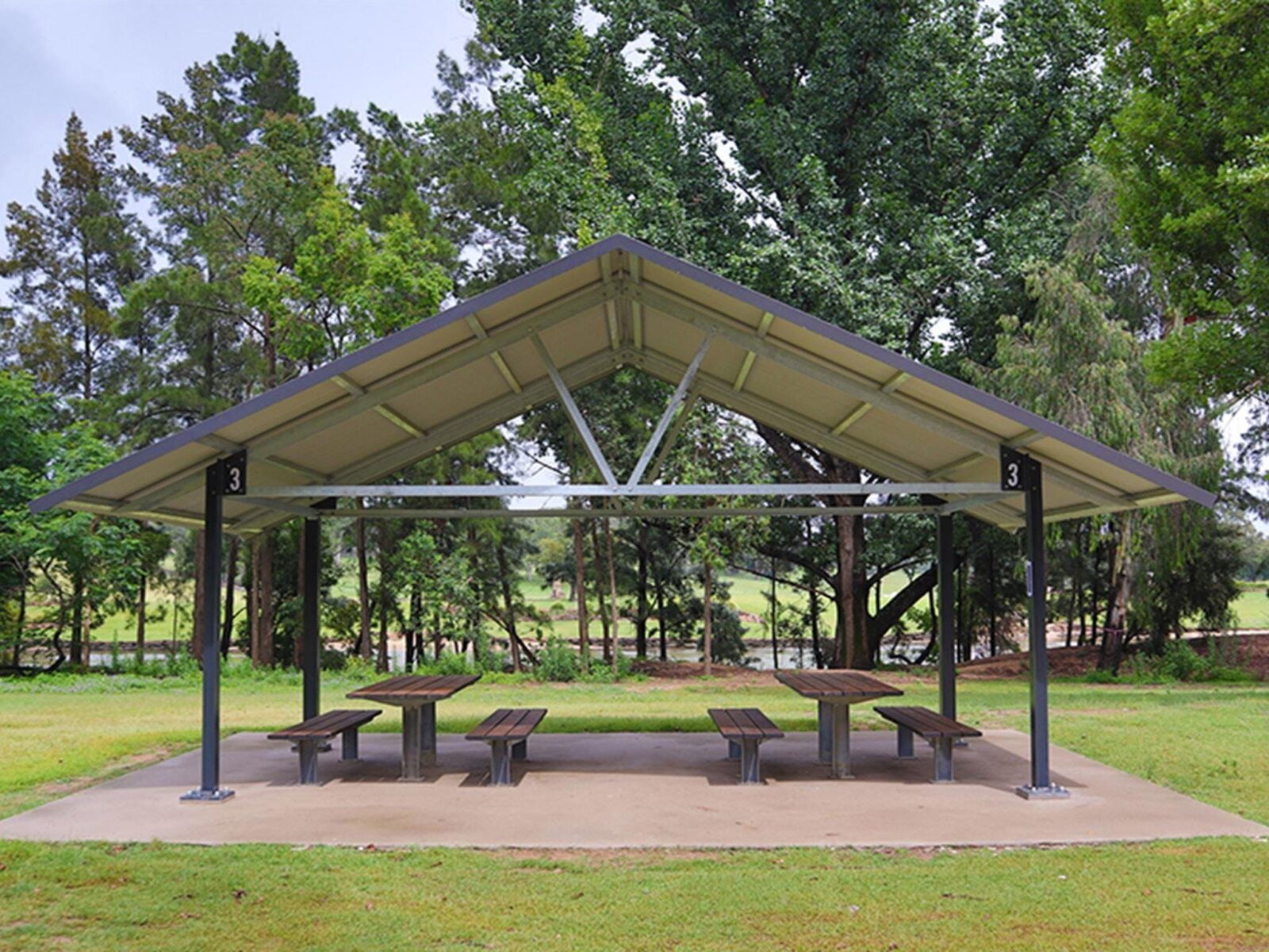 A picnic shed with two picnic tables underneath, at Cattai picnic area in Cattai National Park, on