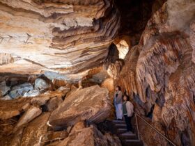 Two visitors exploring the caves at Jenolan. Photo: Jenolan Caves/DPE.