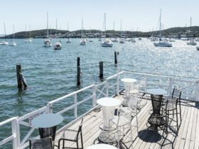 Enjoy a drink on the deck overlooking the beautiful lake and marina