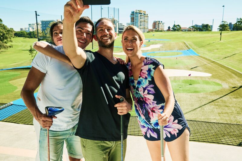 Four people taking a selfie at the Driving Range