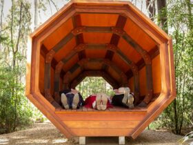 Three pairs of feet are visible in the Sound Pod on the Wellness Walk in Bago State Forest