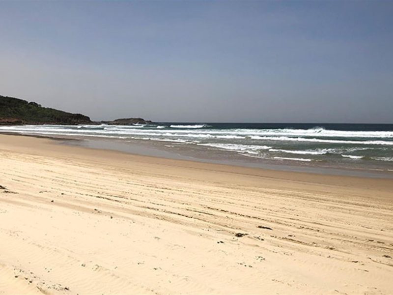 View of the Samurai Beach shoreline with a rocky headland in the distance. Photo: Jim Cutler ©