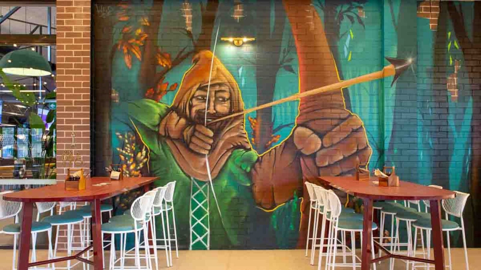 A Mural of Robin Hood A man in a cape with a bow and arrow