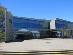 Exterior of Wagga Wagga City Library, blue sky and glass window covered building