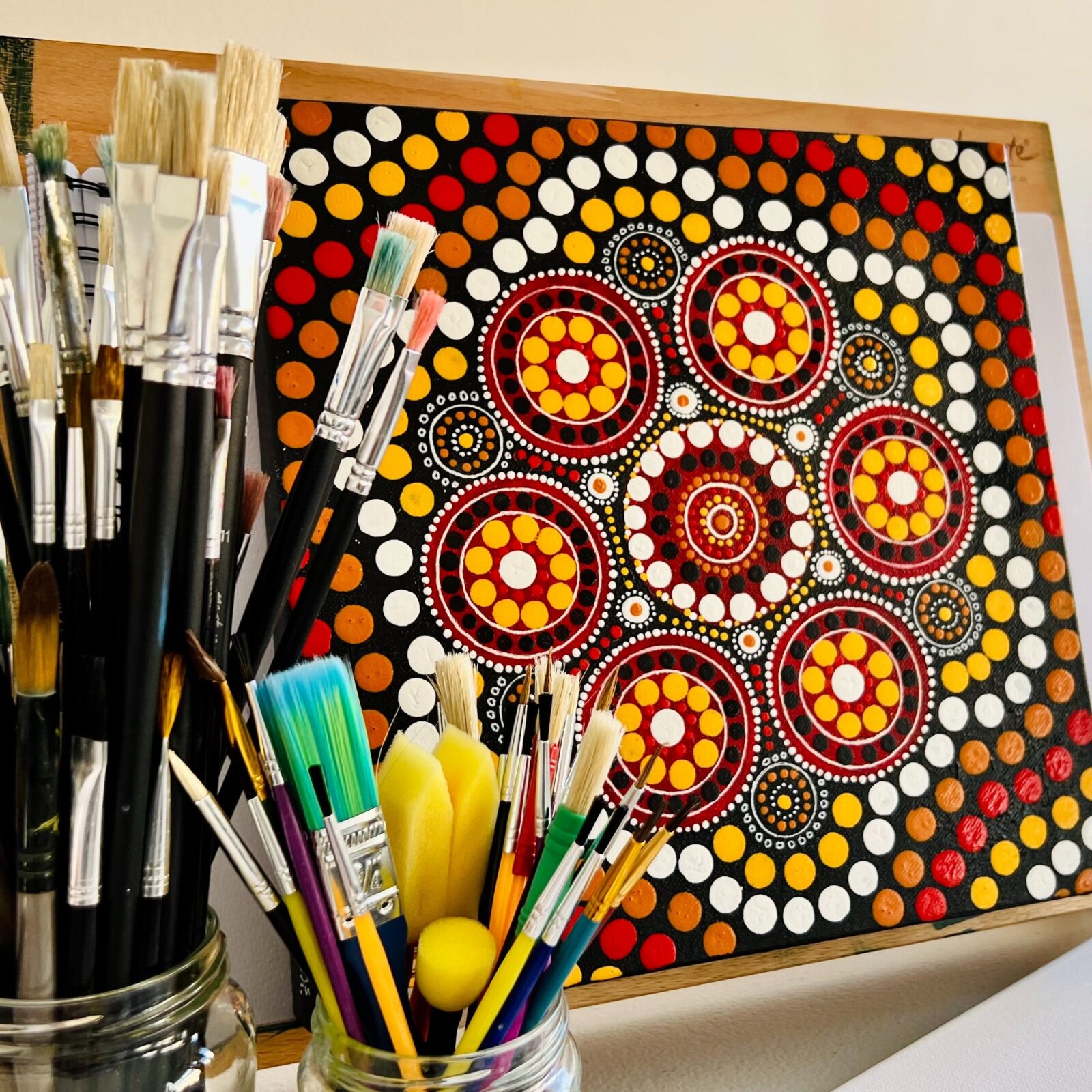 Gamilaraay Artist Vivianne Smith jnr's Artwork with paintbrushes in glass jar