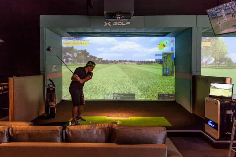 X-Golf Shire | Golfer playing simulator