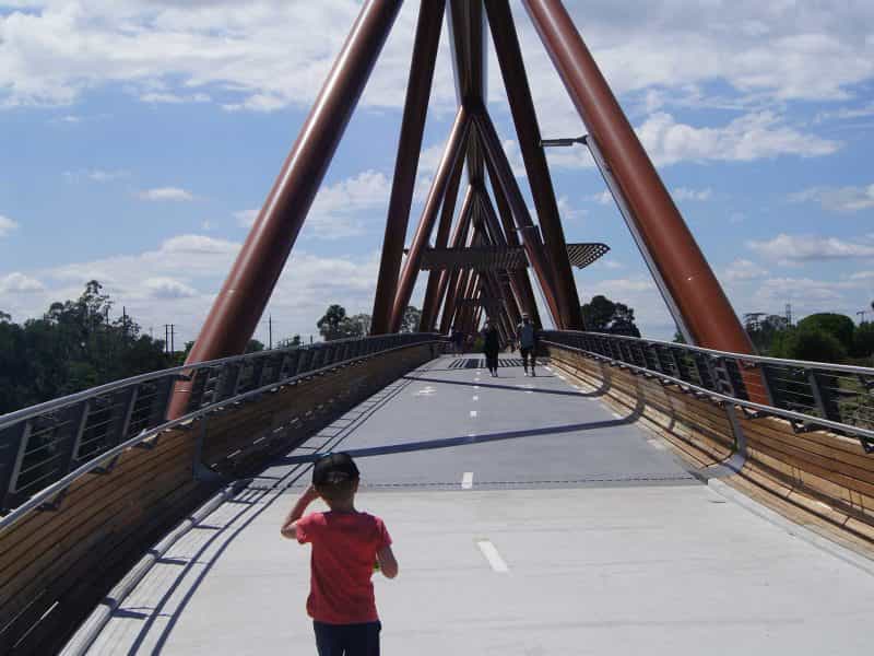 Boy walking over bridge