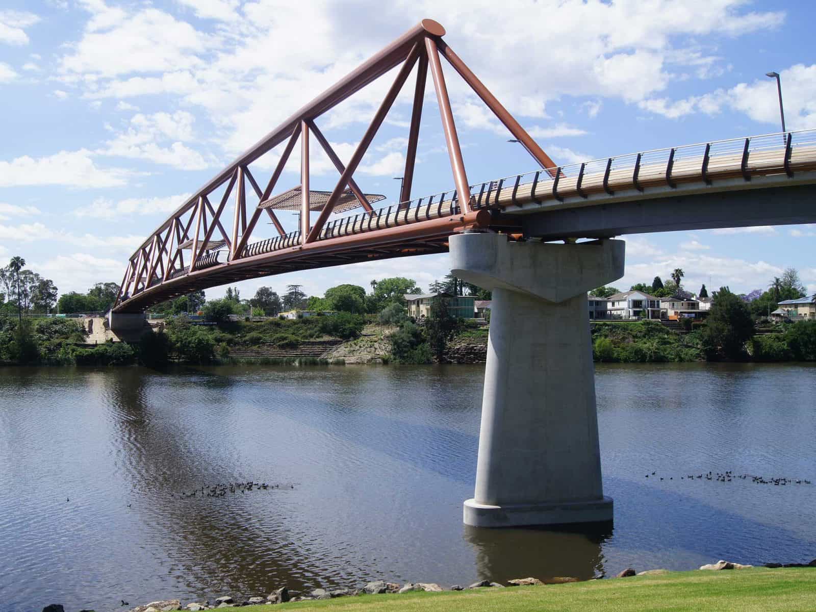 Large orange bridge over Nepean River on sunny day