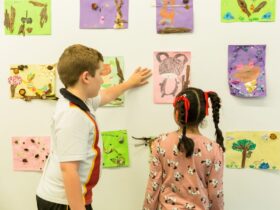 Kids looking at a wall full of artworks
