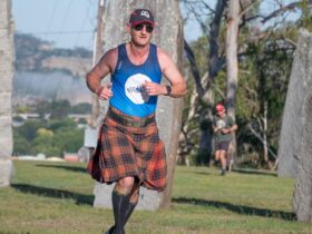 Man wearing tartan kilt running in Australian Standing Stones parkrun event