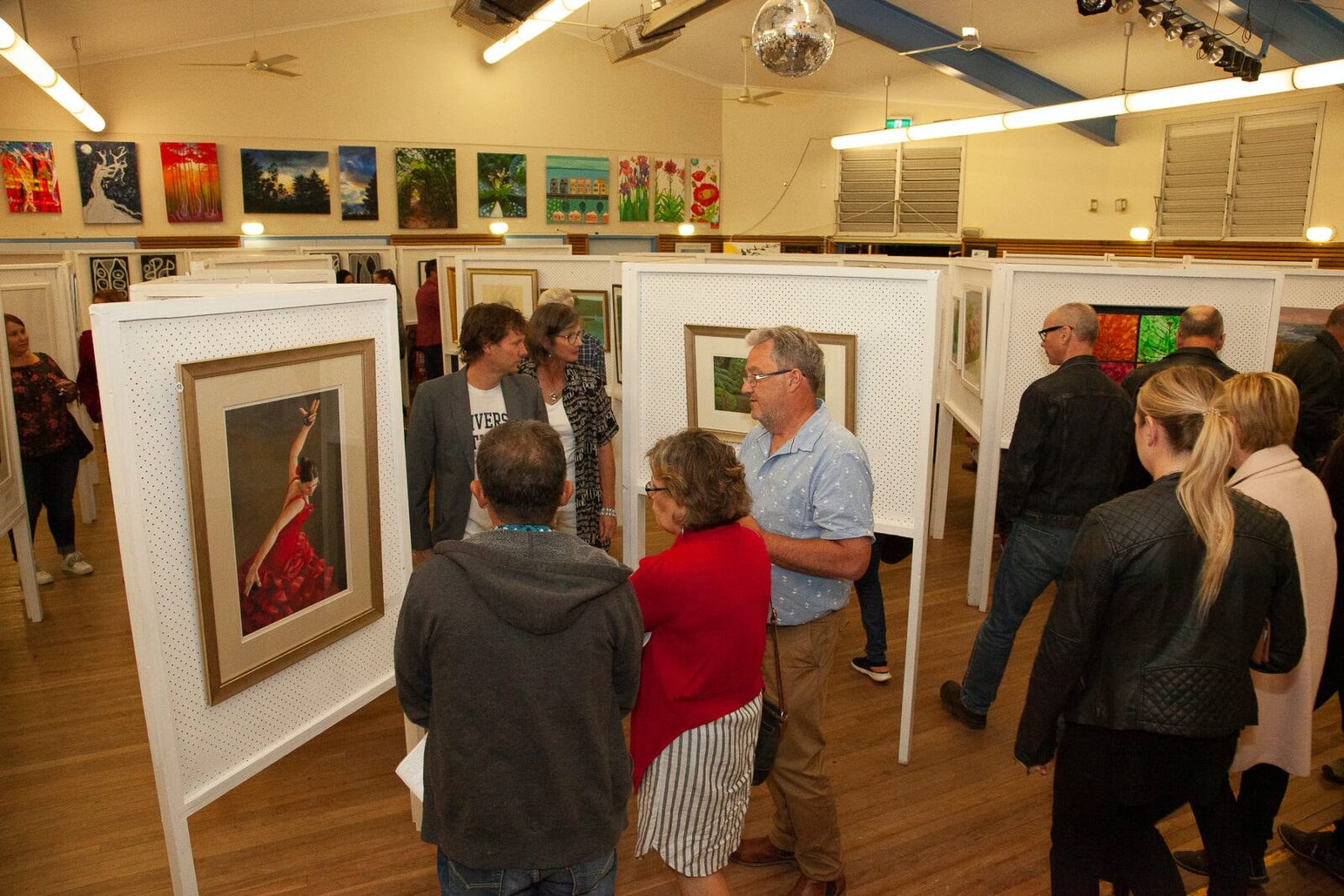 Wentworth Falls School Hall used as an art gallery. Art is displayed on Art Boards & adults browsing