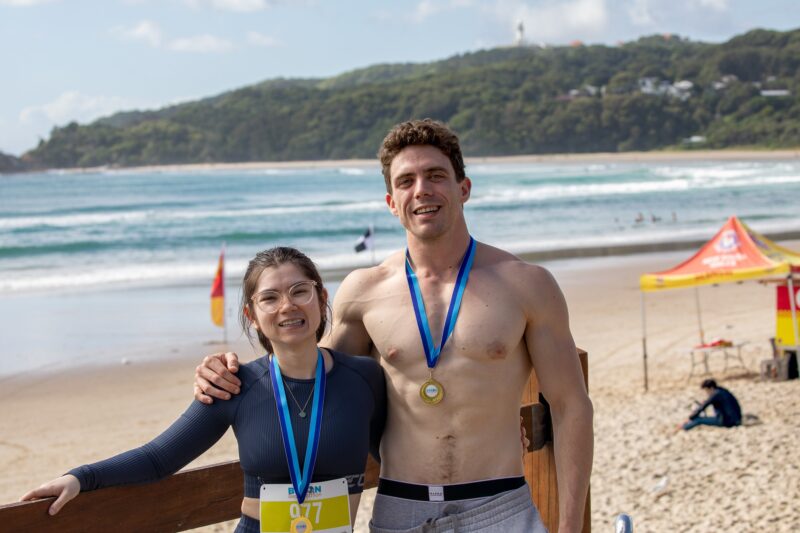 Couple showing off their podium medals